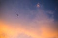 The Abstract airplane fly on sky clouds just sunset. Royalty Free Stock Photo