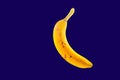 Abstract alienated banana with stains exposed and isolated against a dark blue clear background