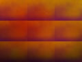 Abstract amber tiled surface pattern with with random colored orange, red, brown squares.