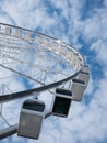 Abstract angle view of a giant ferris wheel with a blue winter sky in the background