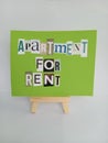 Abstract apartment for rent sign on a wood easel on a white background Royalty Free Stock Photo