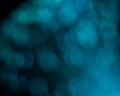 An abstract aqua colored blurred bokeh background with copy space