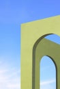 Abstract architecture background of green Tuscany arches wall against blue sky in vertical frame