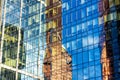 Sky and buildings are reflected in the office skyscraper facade Royalty Free Stock Photo