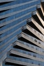 Abstract architecture, modern glass building. Close up view of a spiral modern office building at dusk Royalty Free Stock Photo