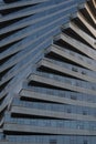 Abstract architecture, modern glass building. Close up view of a spiral modern office building at dusk Royalty Free Stock Photo