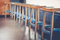 Abstract architecture row of empty vintage wooden chairs decorate in coffee cafe. Royalty Free Stock Photo