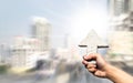 Abstract arrow sign on man hand holding with blurred buildings b