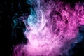 Abstract art colored blue and pink smoke on black isolated background. Royalty Free Stock Photo