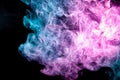 Abstract art colored blue and pink smoke on black isolated background. Royalty Free Stock Photo