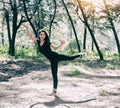 The abstract art design background of beauty lady wearing black suit and satin ballet shoes,posing ballet pattern,in forest Royalty Free Stock Photo