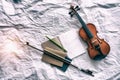 The abstract art design background of violin put beside the opened book and bow Royalty Free Stock Photo