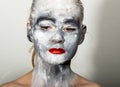 Abstract art makeup. Face and neck girls smeared with gray colors and bright red lips. Holi Festival Royalty Free Stock Photo