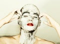 Abstract art makeup. Face and neck girls smeared with gray colors and bright red lips. Holi Festival Royalty Free Stock Photo