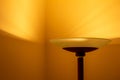 Art view of a modern pole lamp casting light upon a wall corner Royalty Free Stock Photo