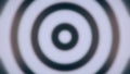 Abstract background with animated hypnotic tunnel of monochrome circles, seamless loop. Animation. Blurred moving round