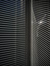 Blinds on the window and a pattern of shadow and light on the wall. Royalty Free Stock Photo