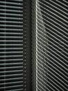 Blinds on the window and a pattern of shadow and light on the wall. Royalty Free Stock Photo