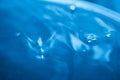 Abstract background with blue liquid, bubbles and light reflection, blurred background Royalty Free Stock Photo