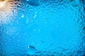 Abstract background. Abstract blur image of blue soft spots and gradients through wet glass. Texture of water drops on glass. Royalty Free Stock Photo