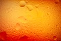 Abstract background. Abstract blur image of orange soft gradients and glare through wet glass. Texture of water drops on frozen Royalty Free Stock Photo