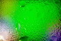 Abstract background. Abstract blurred image of green soft gradients and lens flares through wet glass. Texture of water drops on Royalty Free Stock Photo