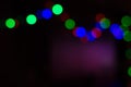 Abstract background with blurred multicolored lights garlands on a black background Royalty Free Stock Photo