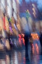 Abstract background of blurred Woman with girl under umbrella, city street in rainy. Intentional motion blur Royalty Free Stock Photo