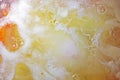 abstract background of boiling soup with scrambled eggs and vegetables top view, flatlay Royalty Free Stock Photo