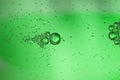 Abstract background from bubbles of carbonated water through a green glass bottle Royalty Free Stock Photo