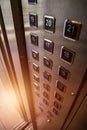 Abstract background of buttons on an elevator panel with button for visually impaired with sunlight in skyscraper