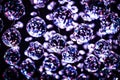 Abstract background - Christmas decoration or crystal chandelier pendant or crystal faceted balls in purple blue tone on black Royalty Free Stock Photo