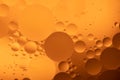 Abstract Background of circles and spheres of oil in water with bubbles macro close up ochre palette Royalty Free Stock Photo
