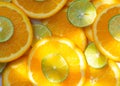 Abstract background with citrus-fruit of orange and lime slices in sunlight. Close-up Royalty Free Stock Photo