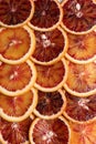 Abstract background with citrus fruit of orange slices. Pattern of orange red citruses. Close-up Royalty Free Stock Photo