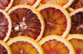 Abstract background with citrus fruit of orange slices. Pattern of orange red citruses. Close-up Royalty Free Stock Photo