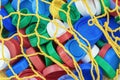 Abstract background of colorful PET plastic bottle caps in mesh string bag stored for recycling, texture, top view Royalty Free Stock Photo