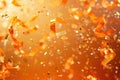 Golden Confetti and Ribbons Falling on Orange Background Royalty Free Stock Photo