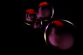 abstract background consisting of dark bubbles of liquid highlighted by neon on a black background. 3D render