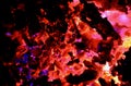 Abstract background consisting of lights of different colors from the burning of plastics on coal. Royalty Free Stock Photo