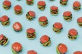 abstract background consisting of patterns of burgers on a blue background. 3d render