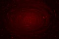 Abstract background of dark red blood paint swirling into a whirlpool