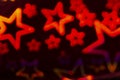 Abstract background with defocused red star shapes, party template with neon colors