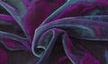 Abstract background of draped iridescent synthetic fabric Royalty Free Stock Photo