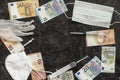 Abstract background of euro banknotes, disposable face mask, syringes, medical gloves. Healthcare and finance concept