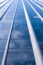 Abstract background of facade of modern glass building with white clouds reflected in it. Royalty Free Stock Photo