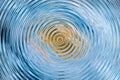 Blue and gold concentric ripple background with abstract water wave circles Royalty Free Stock Photo