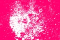 Abstract background featuring a dynamic splash of white droplets over a vivid pink backdrop Royalty Free Stock Photo