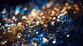 Abstract background featuring sparkling golden glitter over a dark blue bokeh effect, evoking a magical night sky. Royalty Free Stock Photo