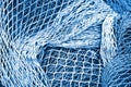Abstract background with fishing net texture toned in blue monochrome Royalty Free Stock Photo
